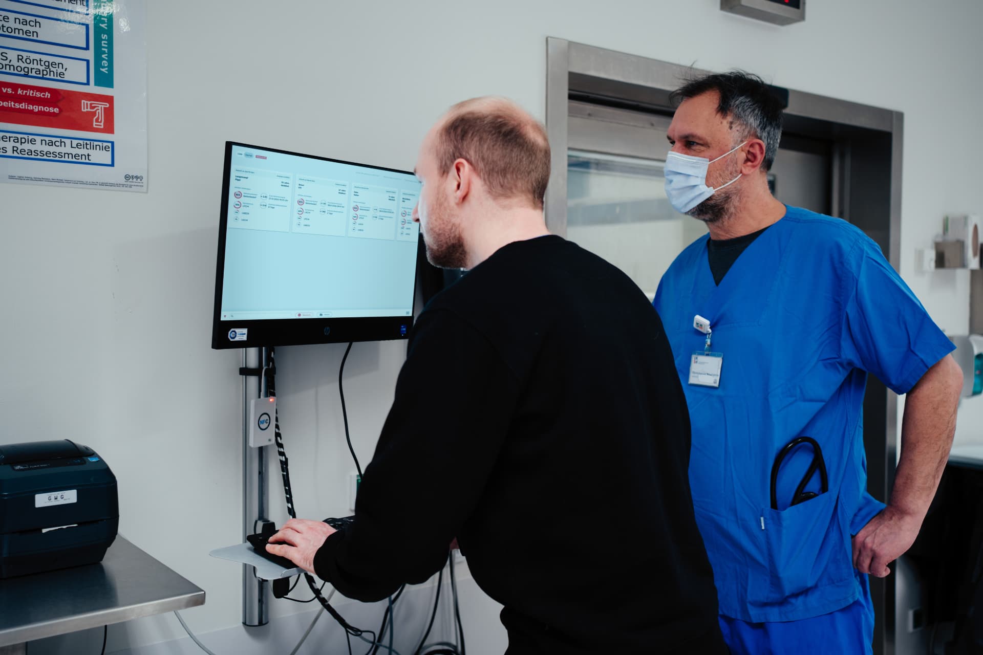 DFKI researcher and clinician evaluating an AI decision-support prototype in a hospital emergency department.