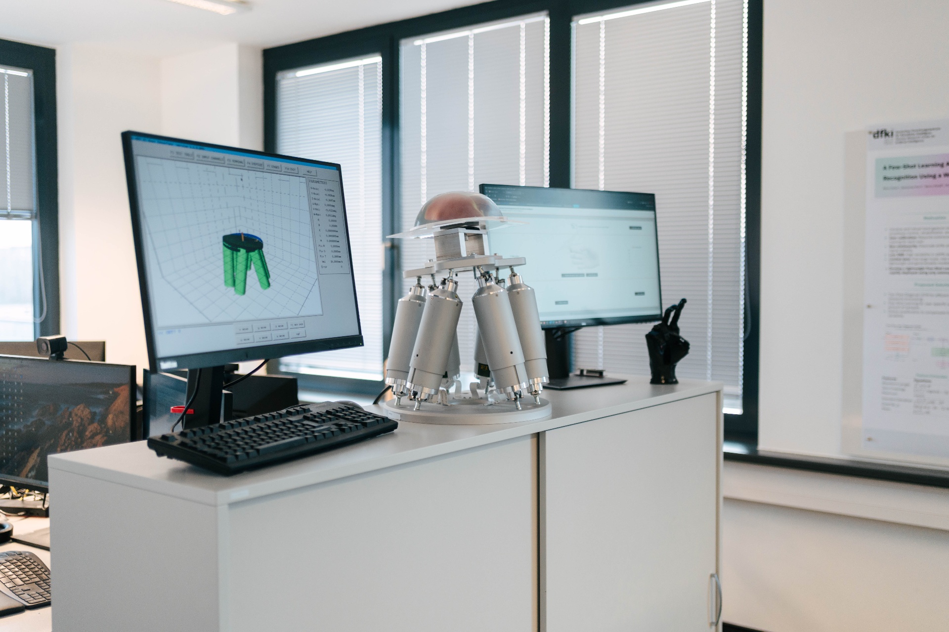 DFKI research lab with parallel robotic platform and simulation workstation